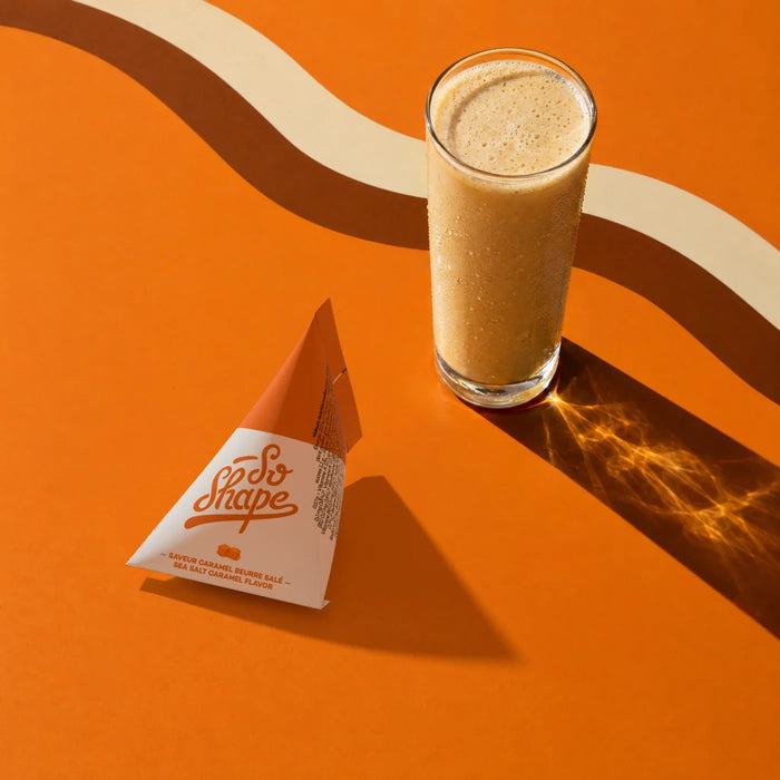 Salted Caramel shake in a glass next to its So Shape sachet