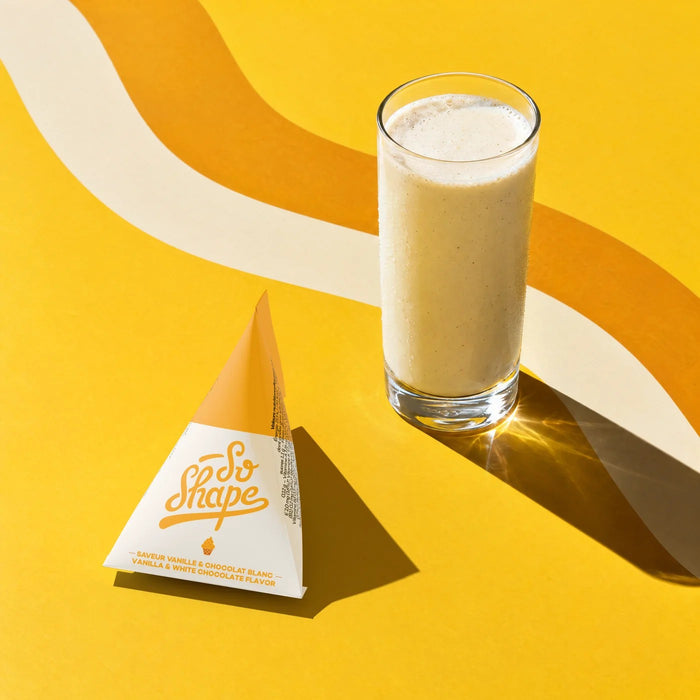 Vanilla & White Chocolate shake in a glass next to its So Shape sachet