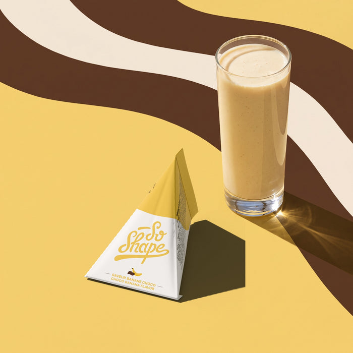 Banana Chocolate shake in a glass next to its So Shape sachet