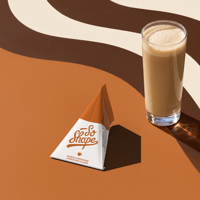 Cappuccino shake in a glass next to its So Shape sachet